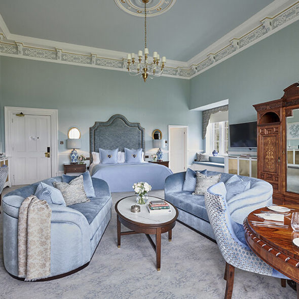 Elegant bridal suite interior with seating area and king-size bed